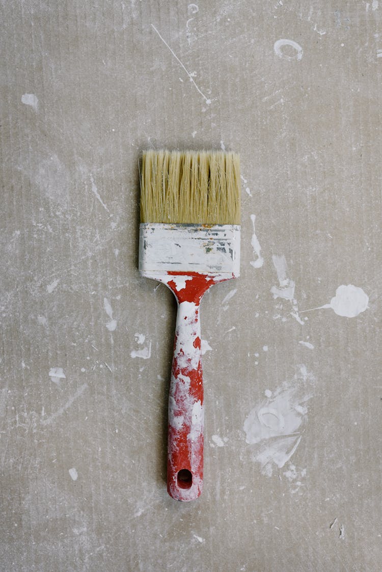 Messy Paintbrush On Dirty Floor