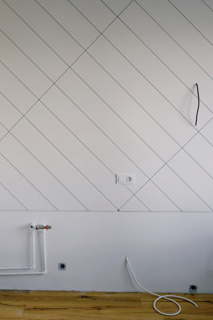 Pipes And Wires On Wall In Room