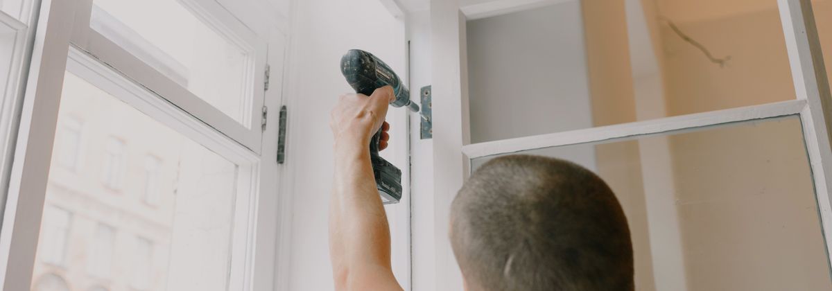 A handyman repairing a cabinet