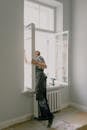 Unrecognizable workman installing window in new apartment