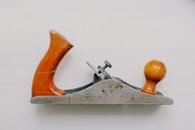 Old rusty plane with polished wooden knob