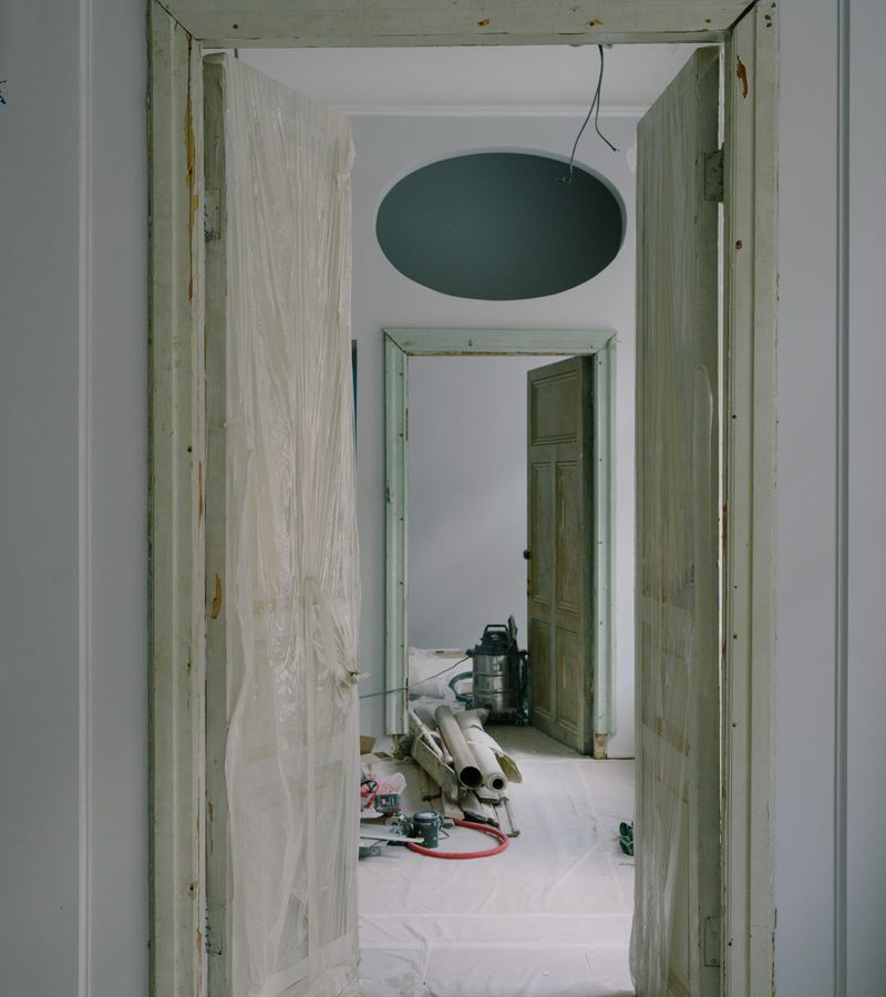 Damp doorway with plastic sheeting, a musty smell after rain often starts in a space like this