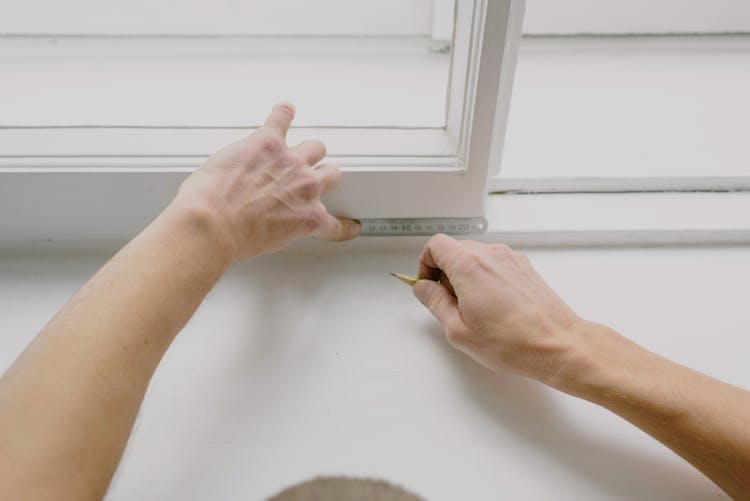 Faceless Workman Measuring Window With Ruler In Flat