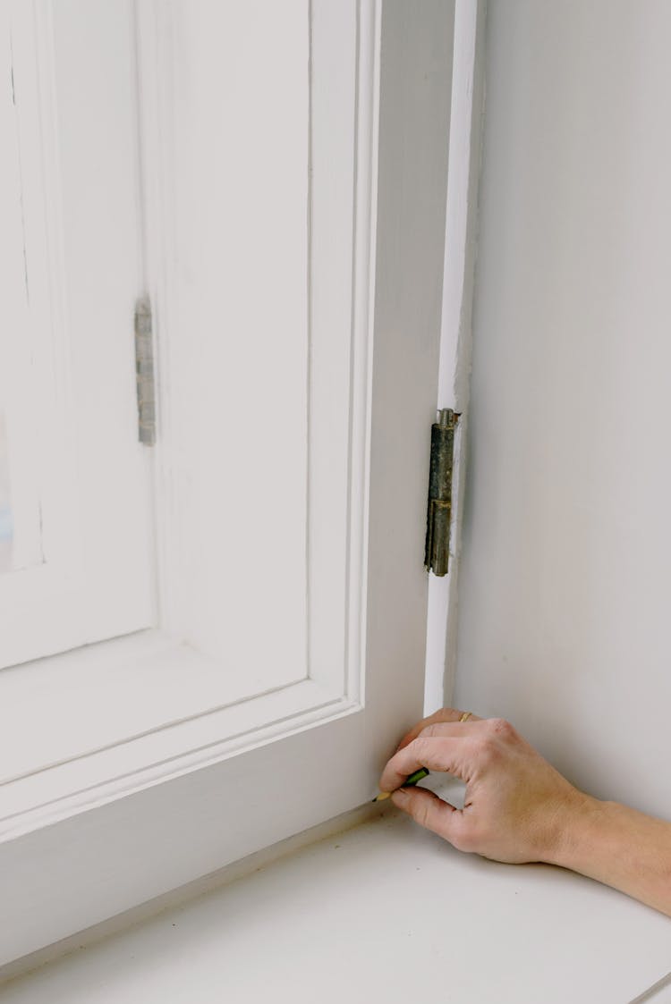 Person Installing Window In Apartment