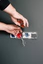 An Electrician Using Pliers to Repair the AC Power Plugs and Sockets