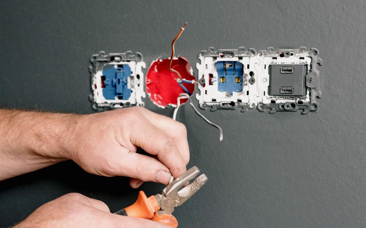 Electrician repairing residential electrical fittings
