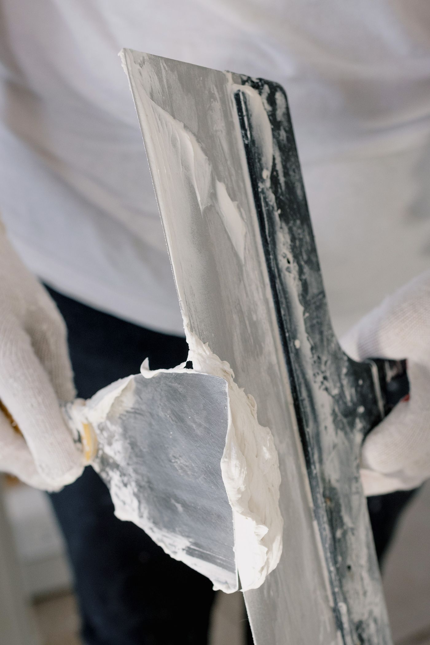 Plasterer working with plaster and trowels