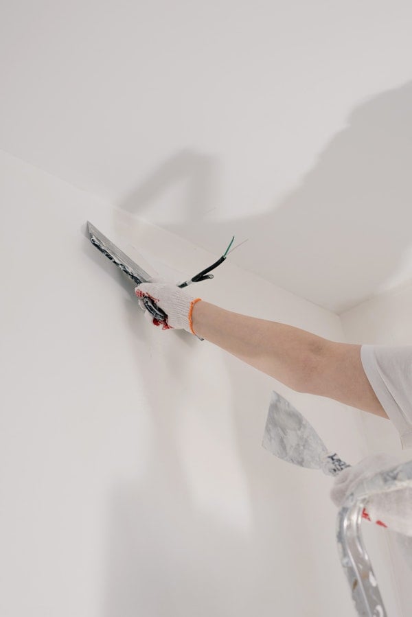 Protective-suited worker performing mold remediation in a home