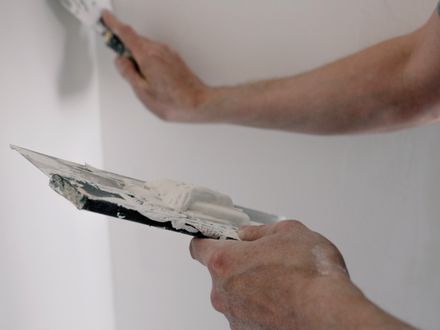 Repaired plaster wall section blended into the surrounding wall