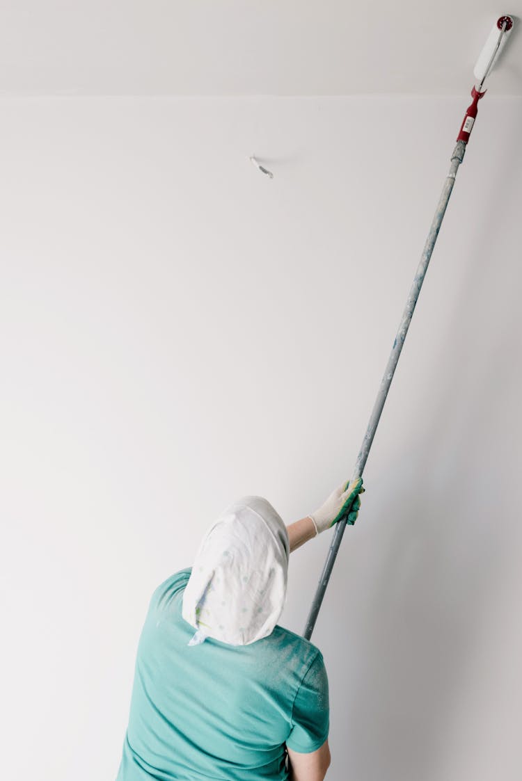 Man With Roller Working In Room