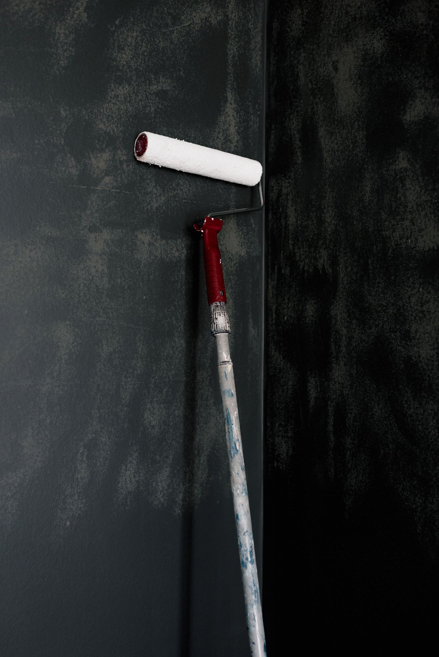Paint roller being used on an interior wall