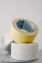 Masking tapes on table against white wall