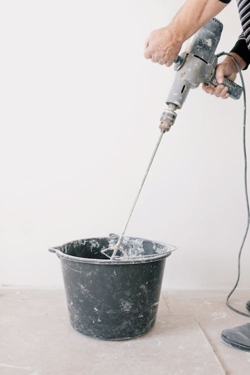 Free Crop man mixing cement in room Stock Photo
