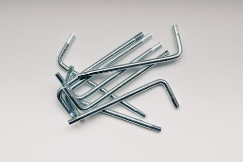 Free From above of different hex keys in heap on white table in workshop Stock Photo