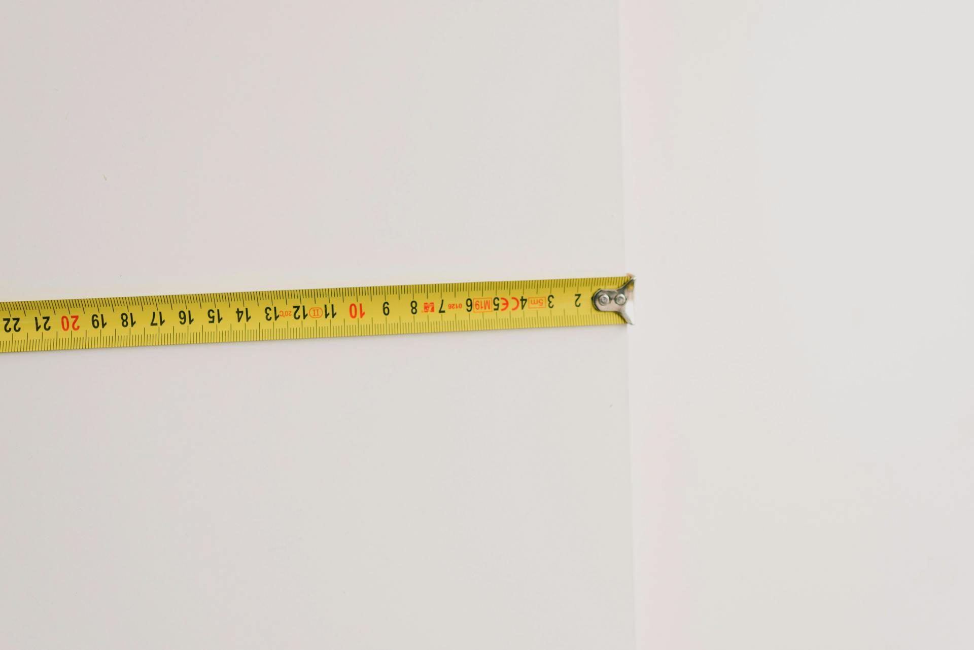 Measuring tape on empty white background
