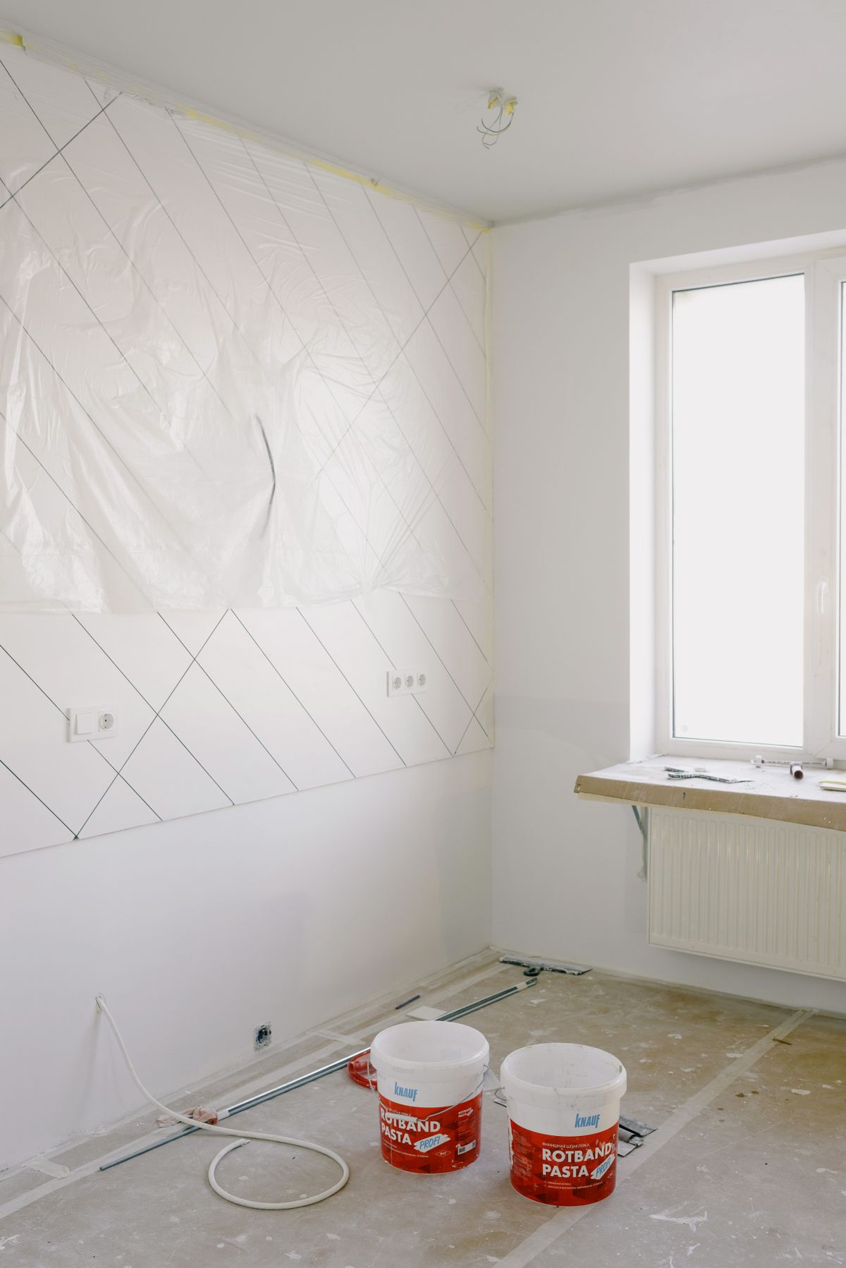 Empty room with masked walls and paint buckets ready for prep work — Brushwork Co. pressure wash and prep