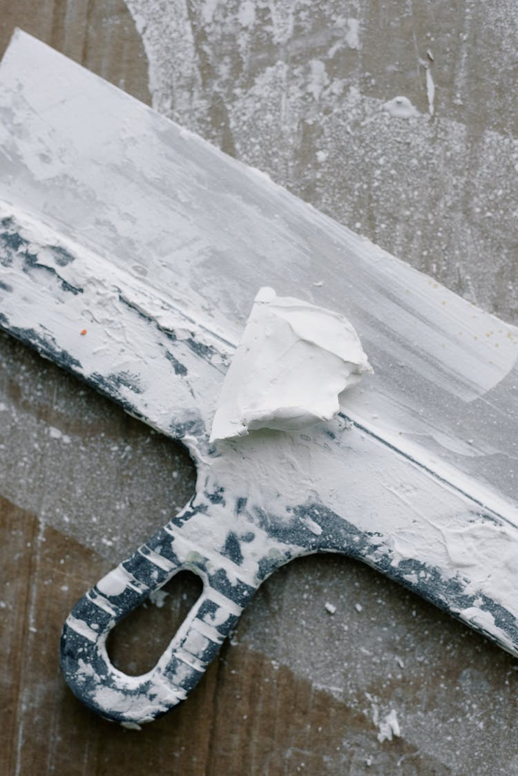 Dirty Spatula In Plaster On Table