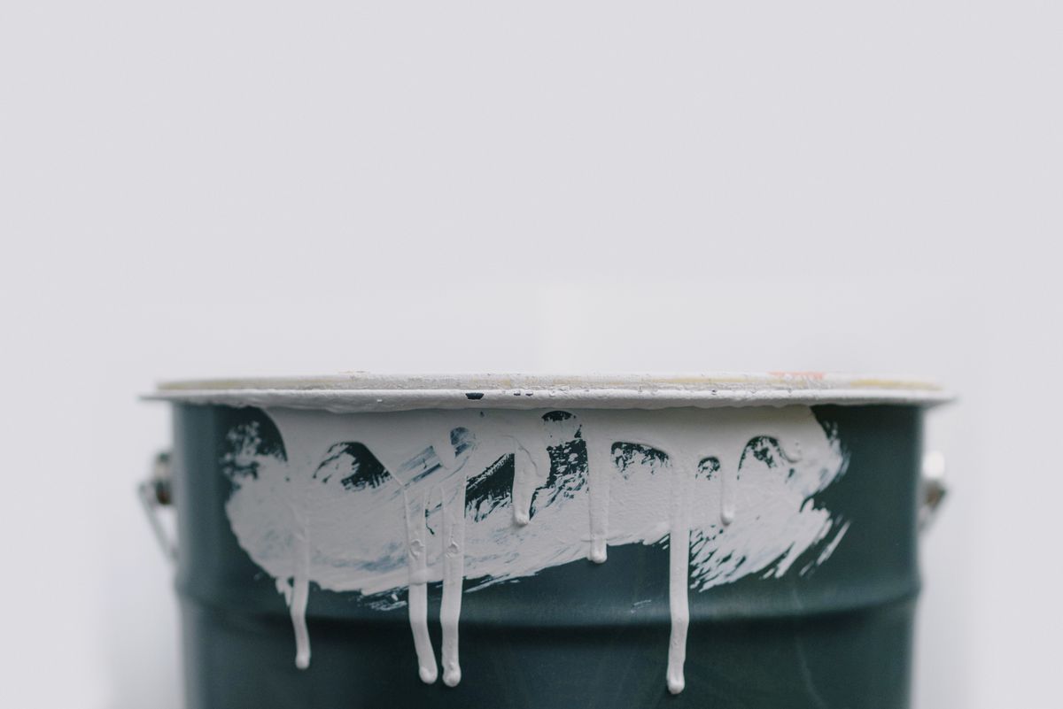 Generic roof sealer style coating bucket with white coating drips