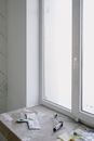 Dirty table near window with tools