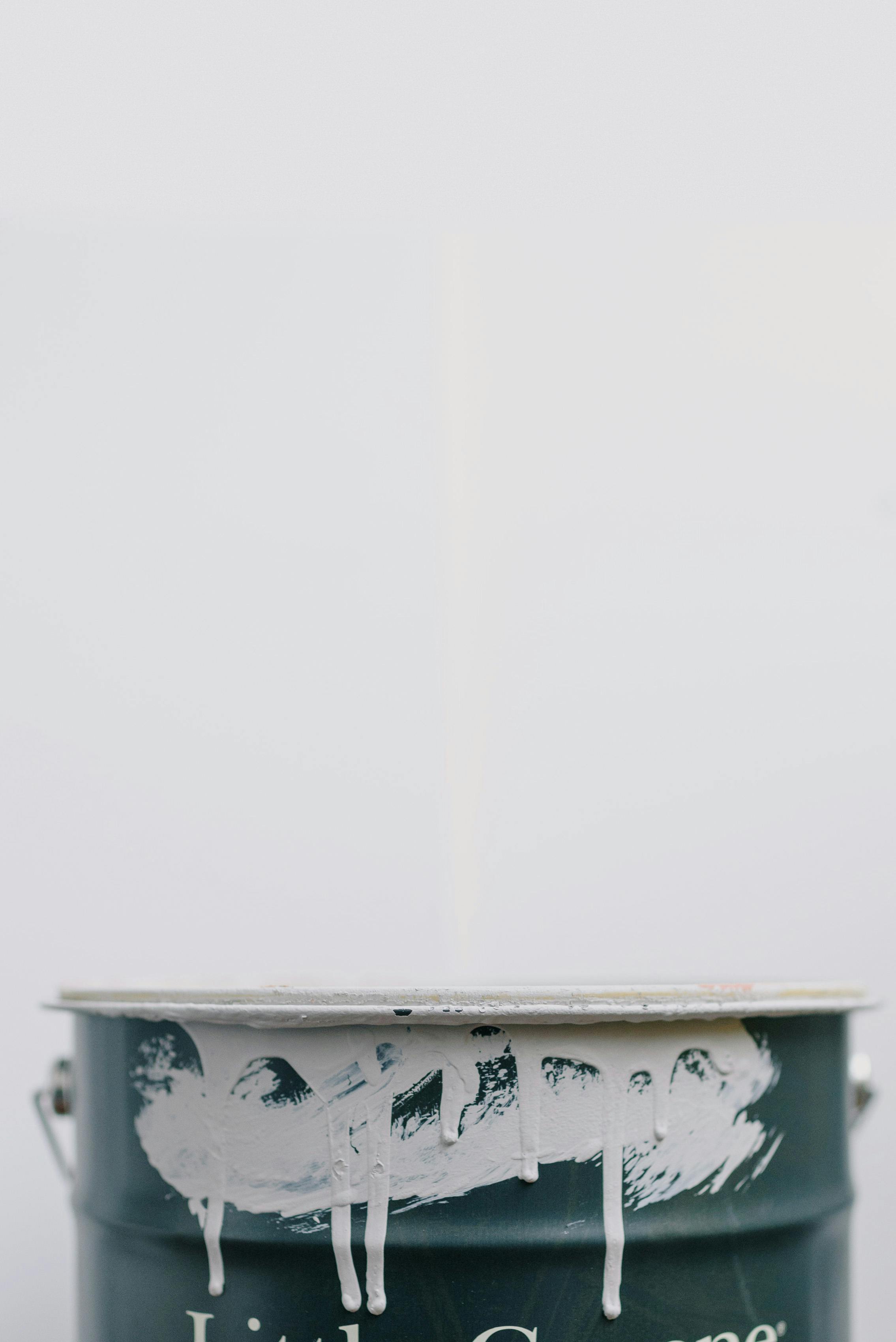 metal bucket in paint against white background