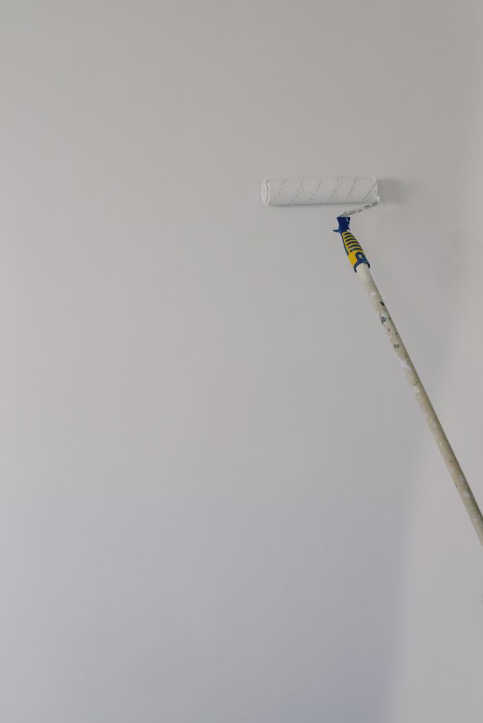 Paint roller on a white wall