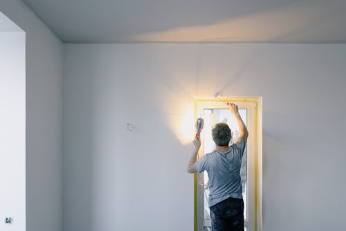 Free Faceless man repairing door in room Stock Photo