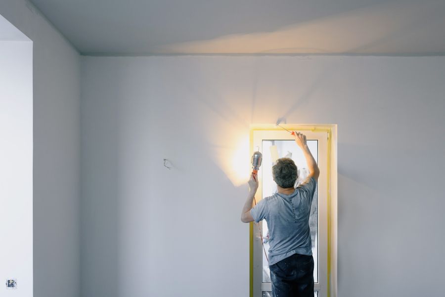 Handyman repairing a door in a home