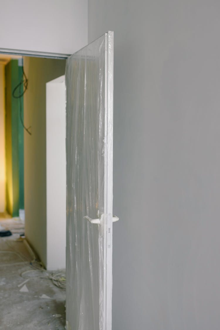 Flat Door In Wrapped Plastic During Renovation