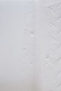 Uneven white surface with grains and traces