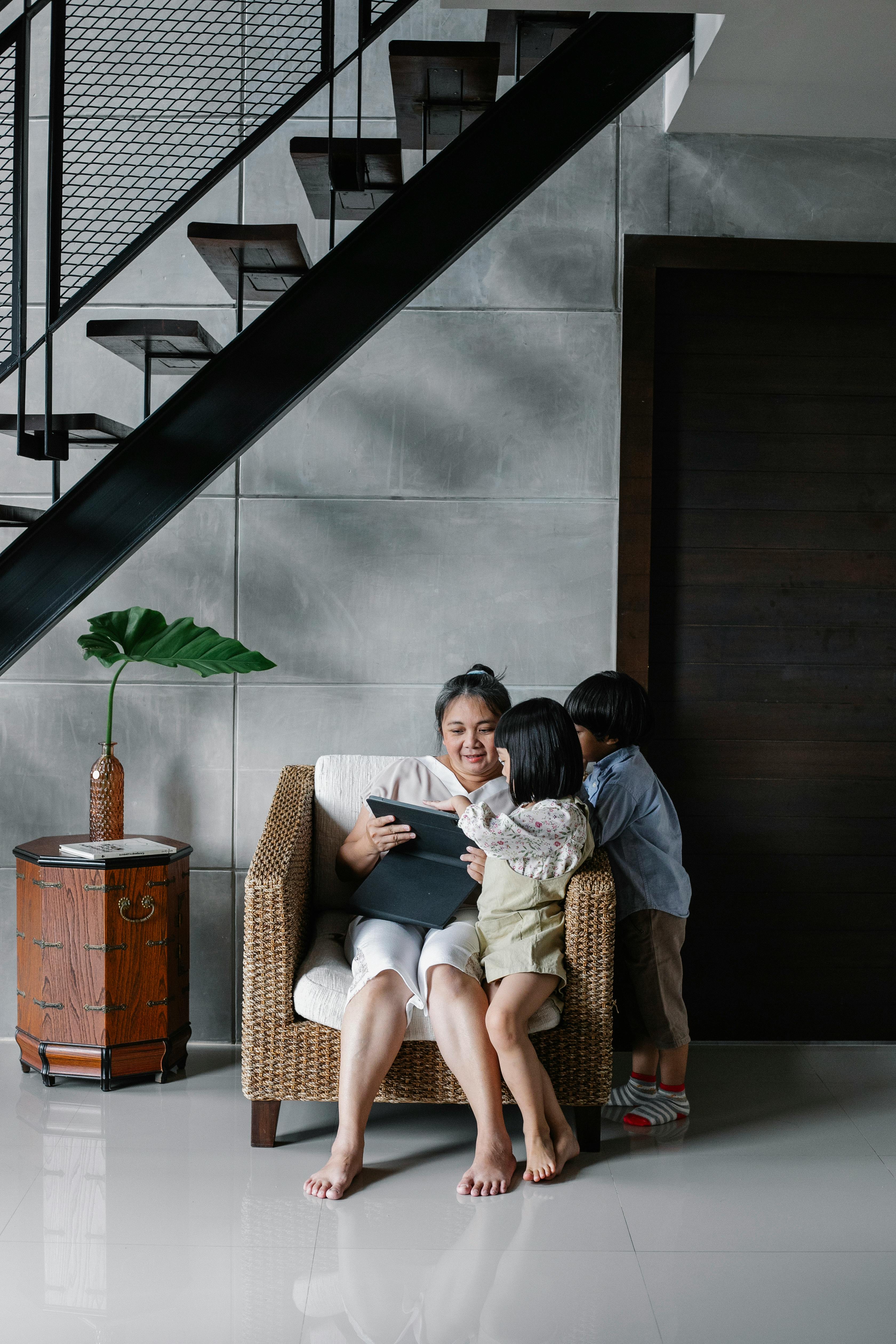 mother with children looking at screen of tablet