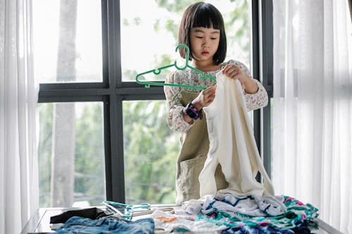 Free Little girl doing housework in room Stock Photo