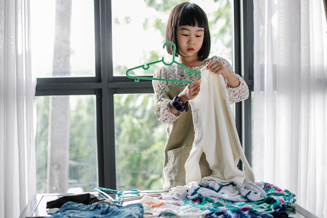 Little girl doing housework in room