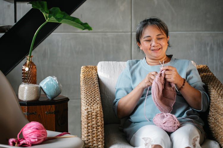 Relaxed Mature Woman Knitting In Armchair