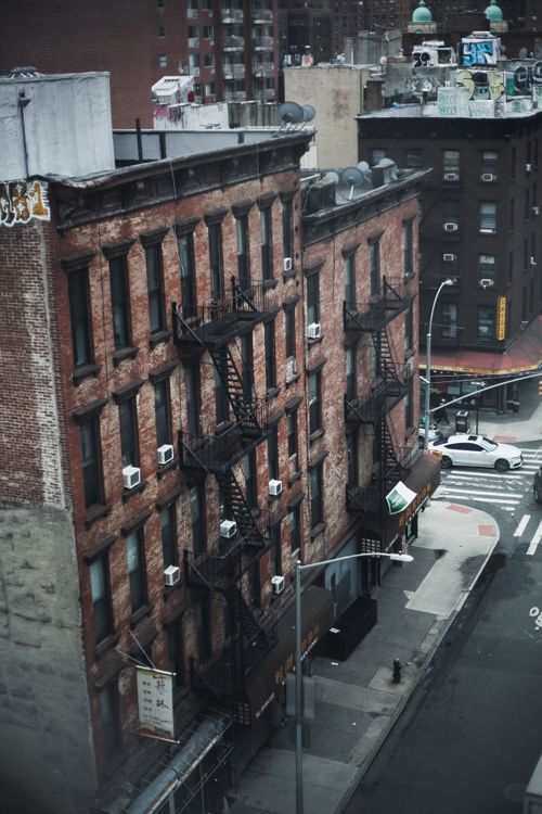 Free High-angle view of historic brick buildings and street corner in New York, showcasing urban architecture. Stock Photo