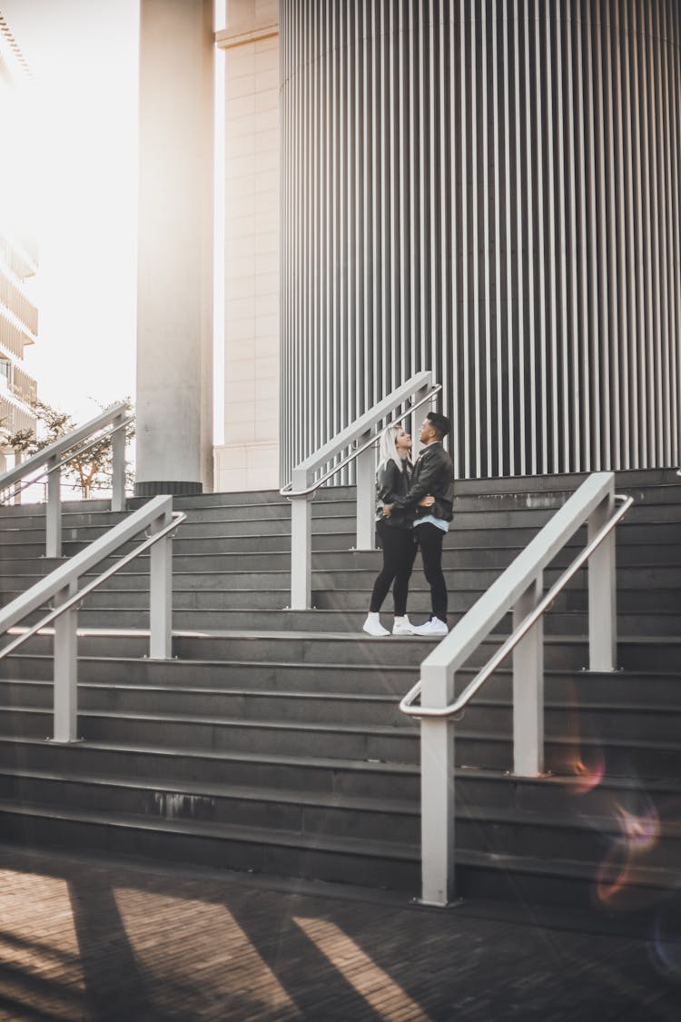 Couple In Black Clothes Hugging Each Other On Stairs 