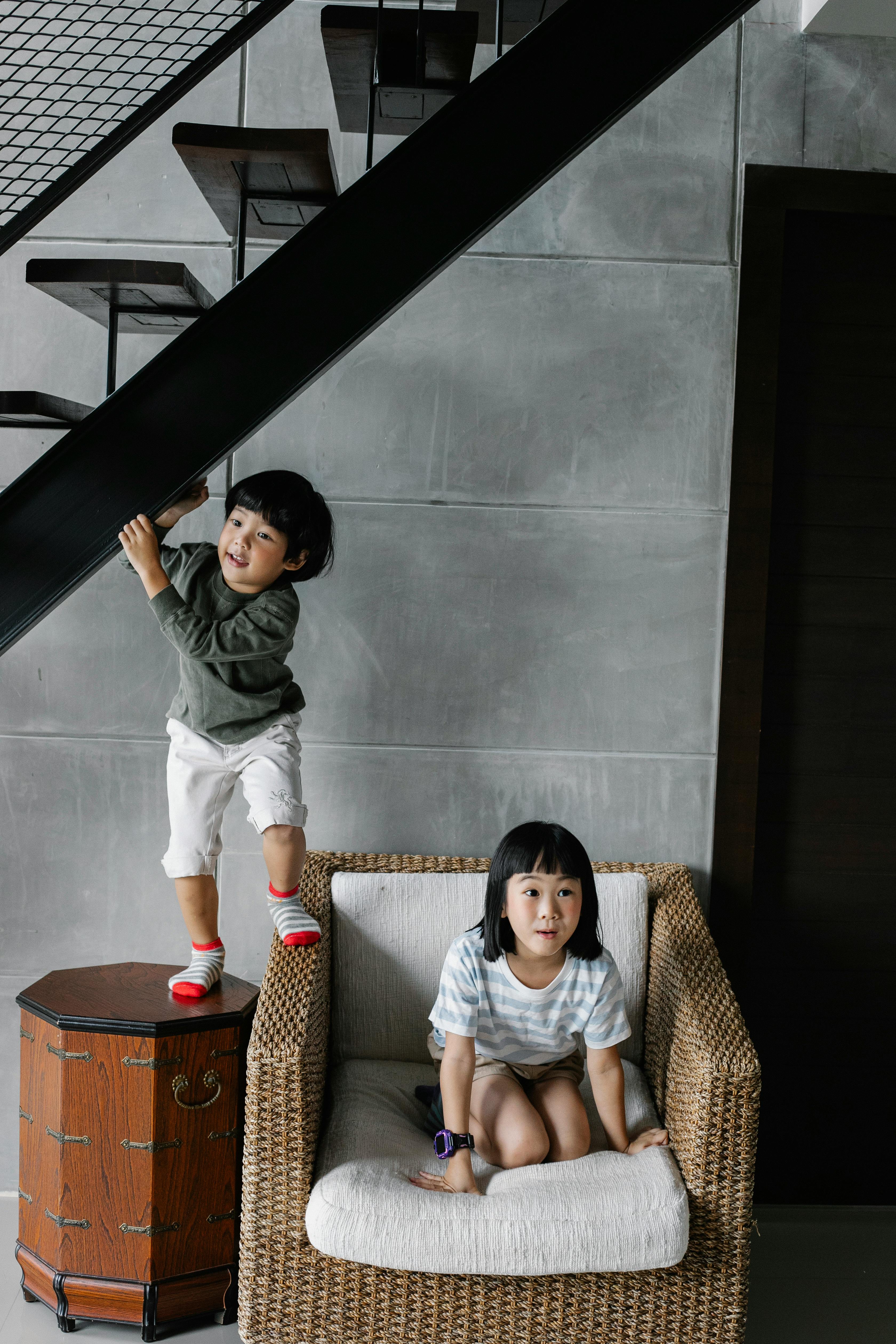 playful little ethnic siblings having fun at home