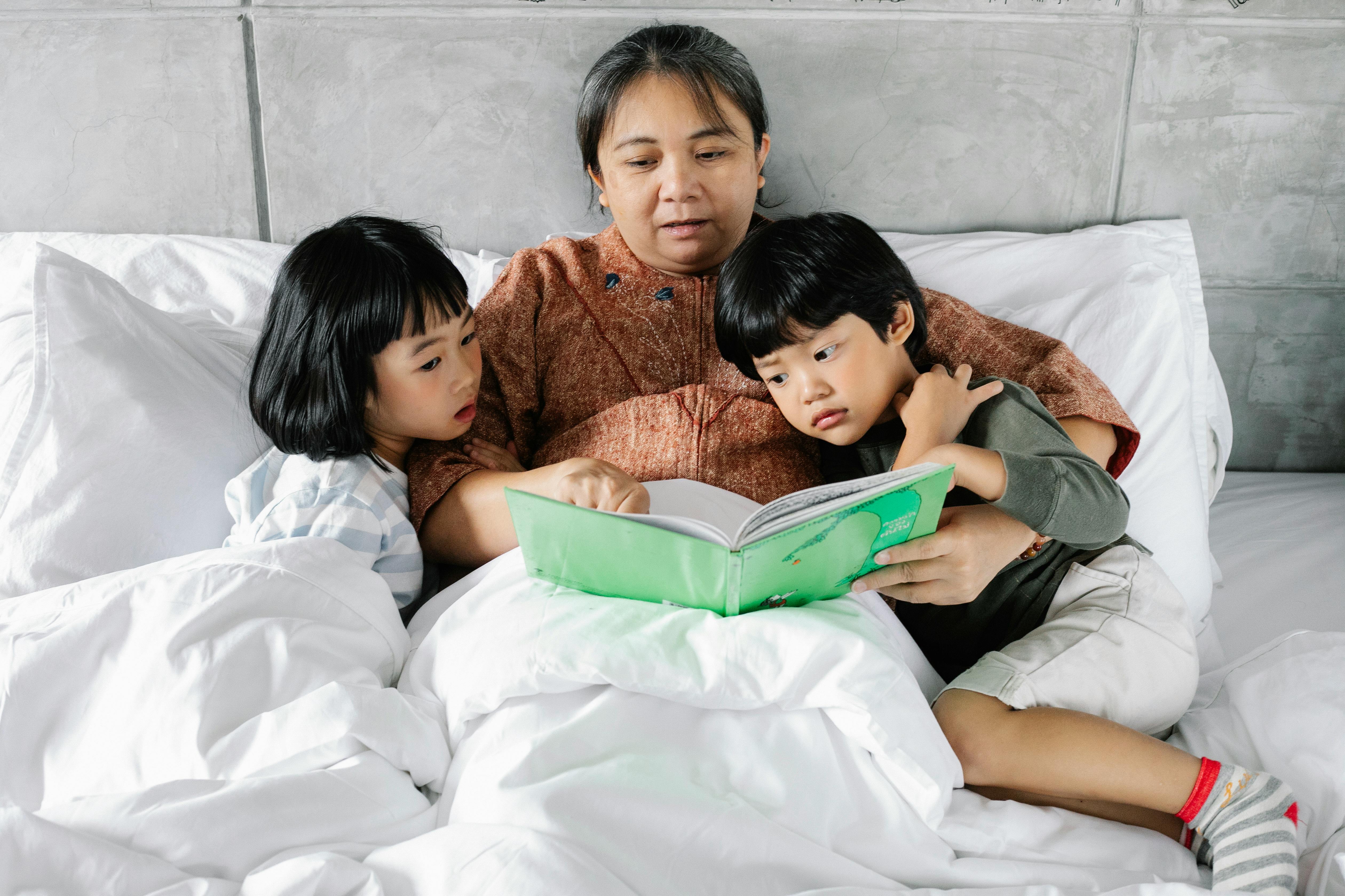 ethnic mother reading fairytale with kids