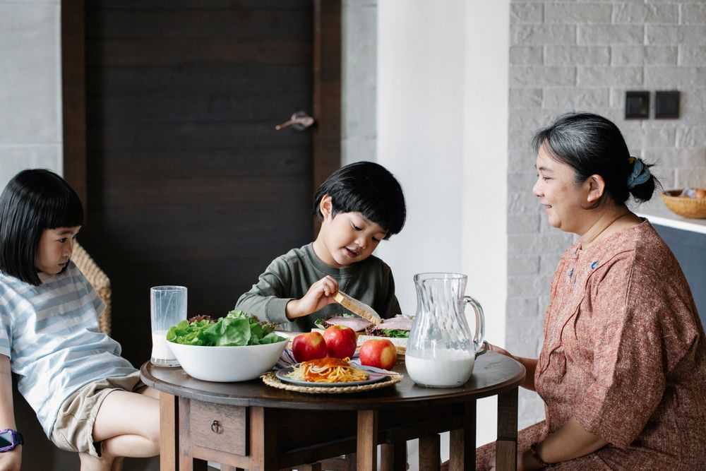 Grandmother sharing a meal with children