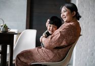 Asian grandmother hugging little boy
