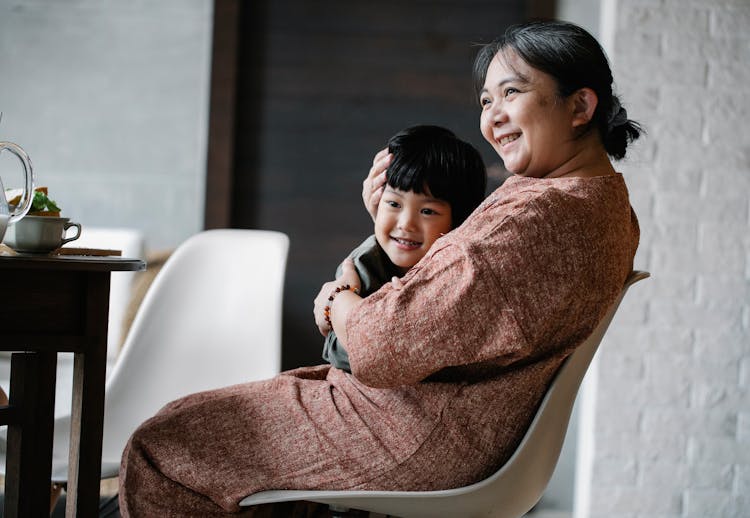 Asian Grandmother Hugging Little Boy