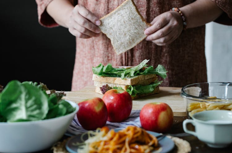 Crop Woman Making Sandwich With Salad