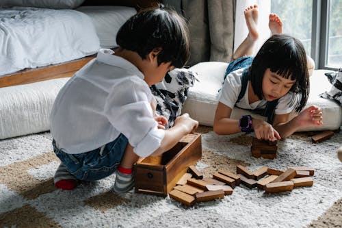 Asian kids playing with wooden blocks