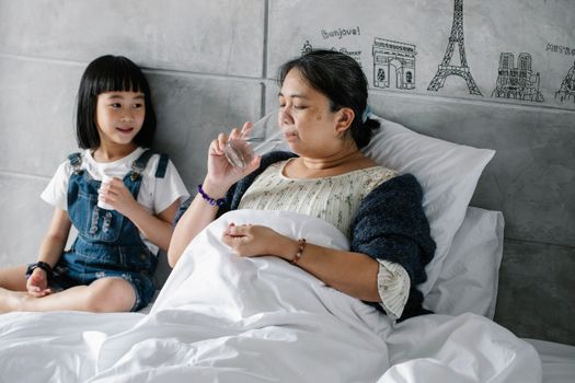 Elderly woman and granddaughter sharing a warm moment at home