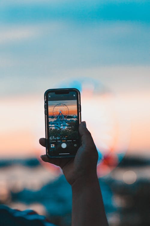 A Person Taking Photo Using A Phone