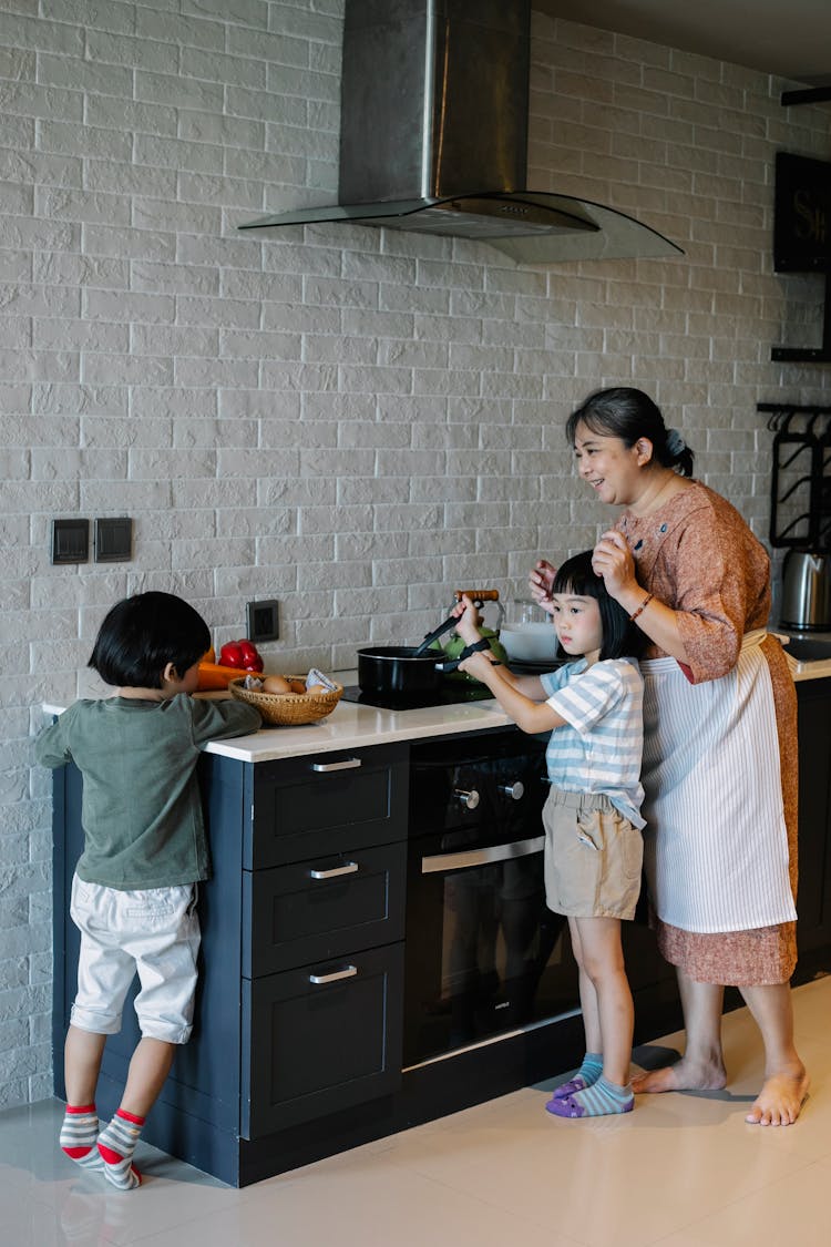 Happy Grandmother With Children In Kitchen