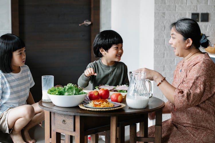 Asian Woman Having Breakfast With Cute Children