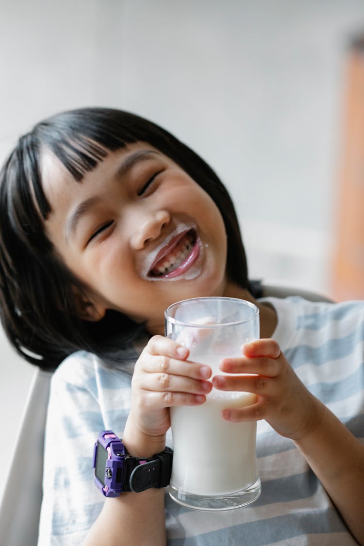 Happy Asian Child With Mouth In Milk