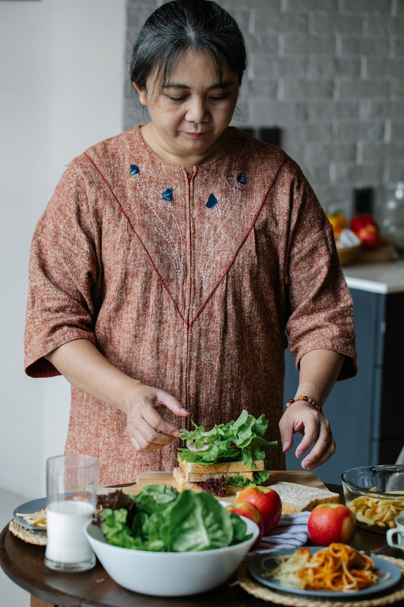 Older Asian woman preparing food in her kitchen