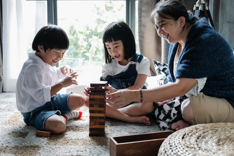 Elderly Woman Playing With Asian Kids