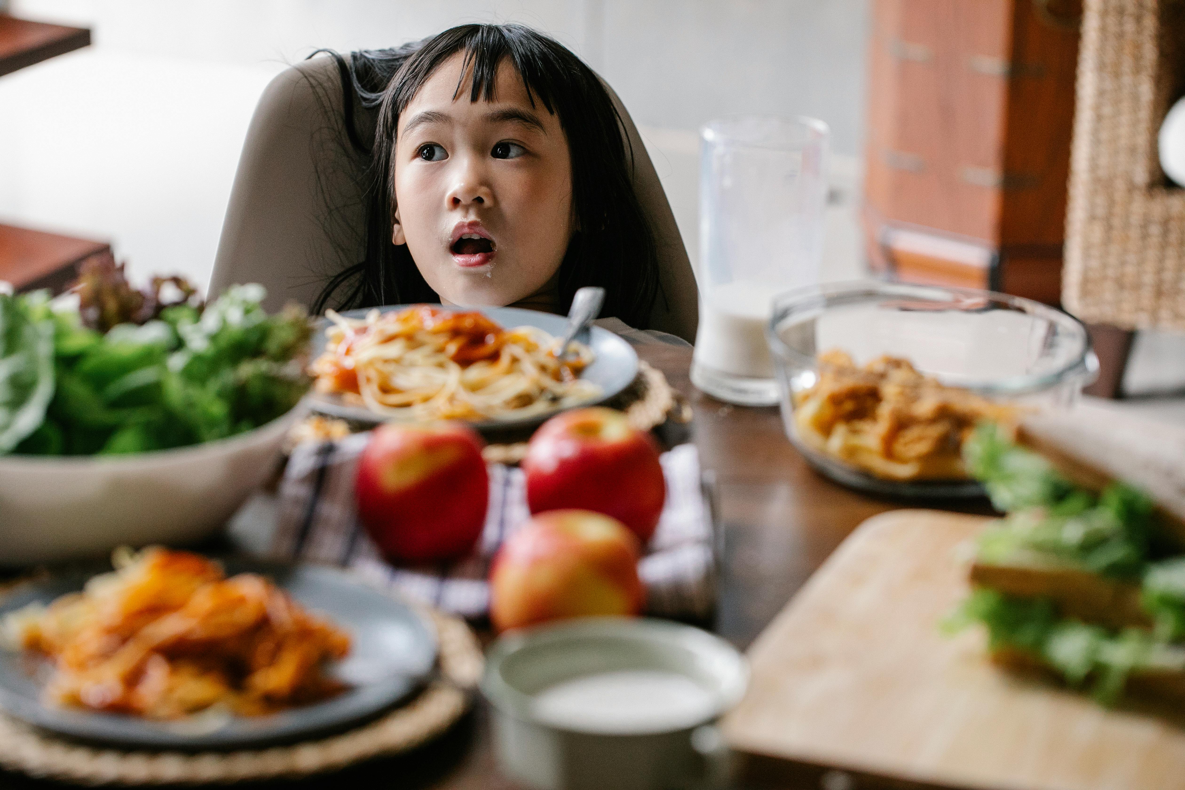 cute little girl having breakfast at home